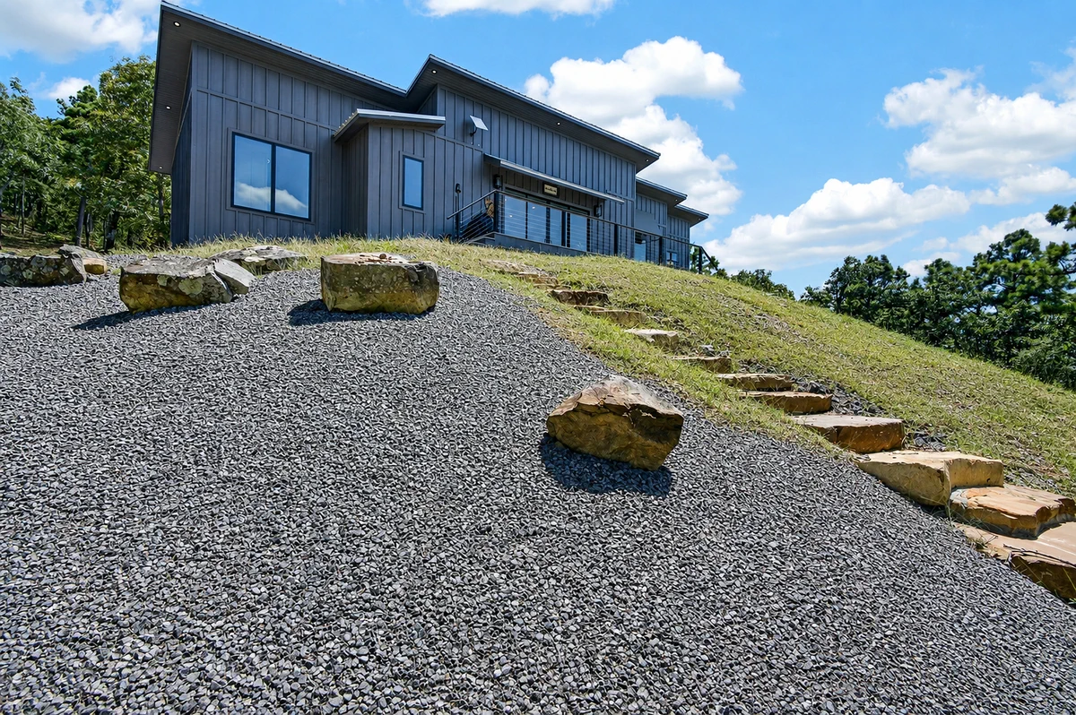 Daylight exterior of 10 Moonshine Drive and its stone-lined approach