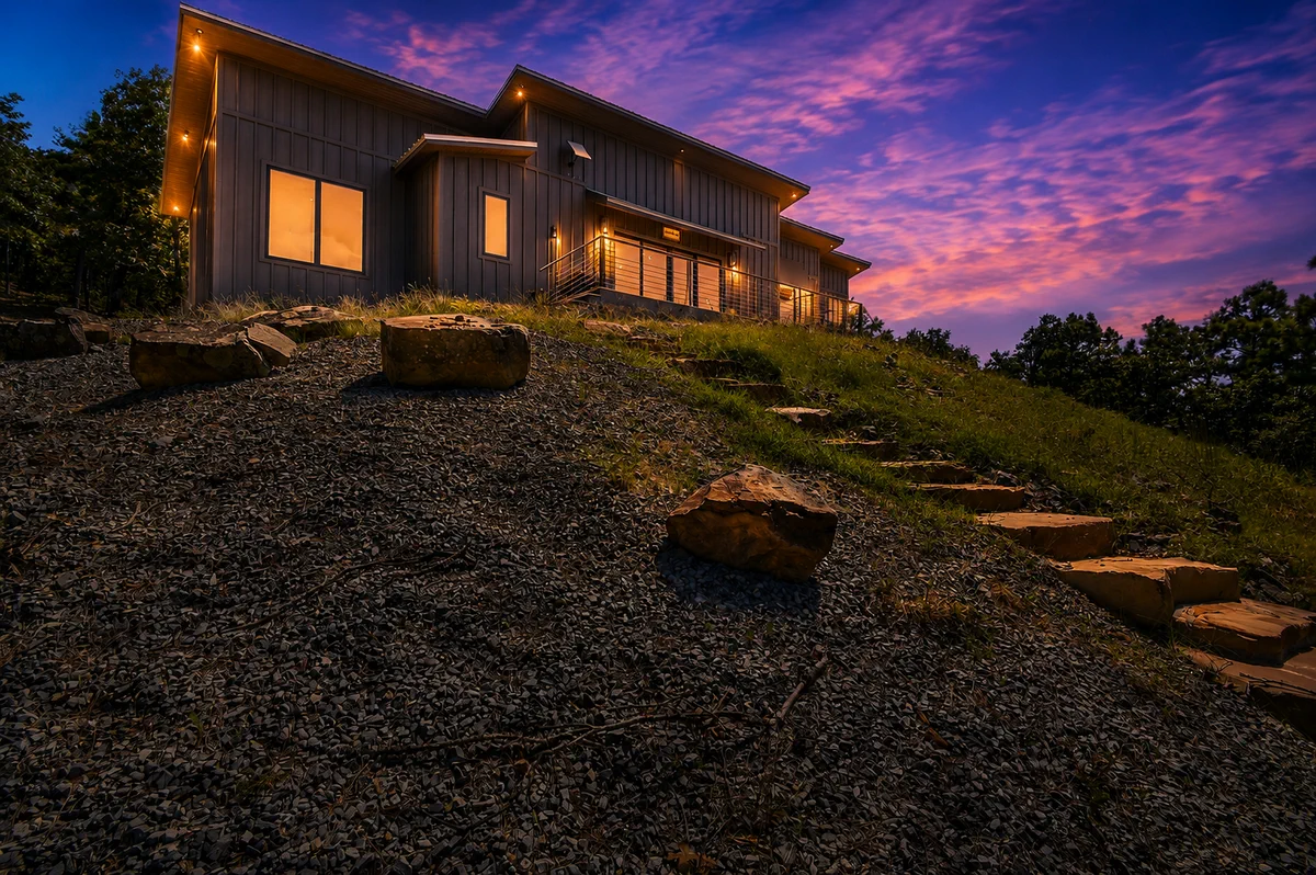 Twilight exterior of 10 Moonshine Drive beneath a vivid mountain sky