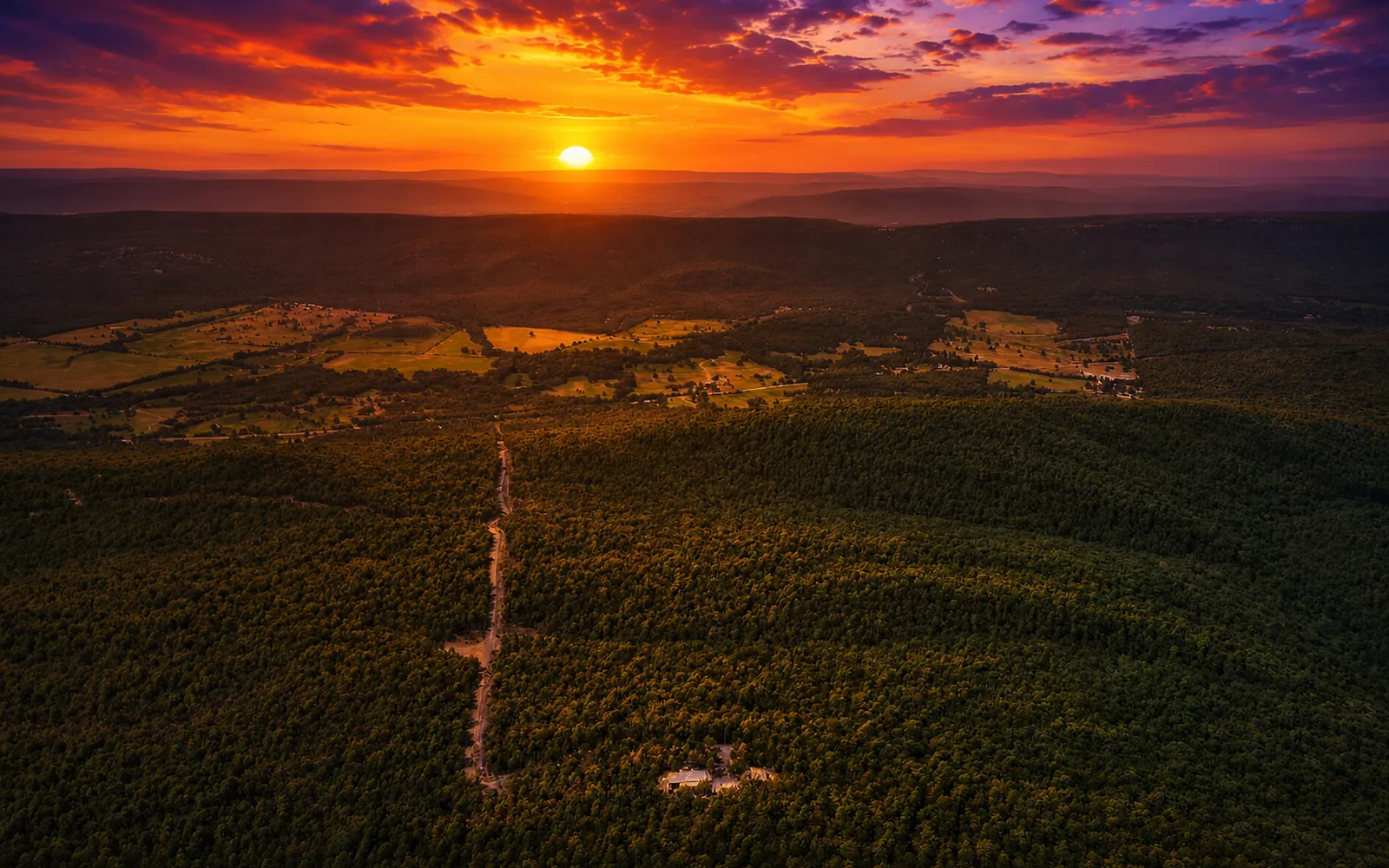 Sunset over the wooded ridges surrounding Moonshine Mountain