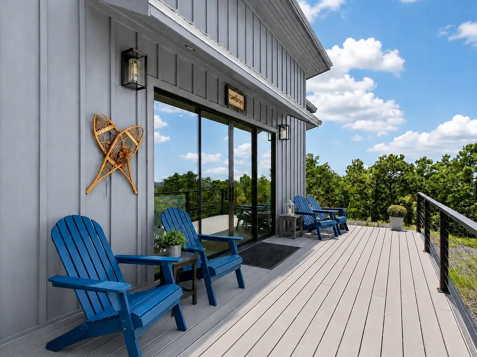 Porch seating with a wooded mountain outlook at 10 Moonshine Drive