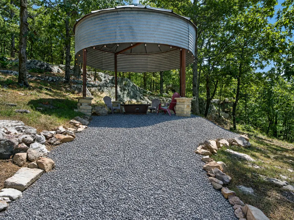 Covered outdoor gathering area among trees at 10 Moonshine Drive