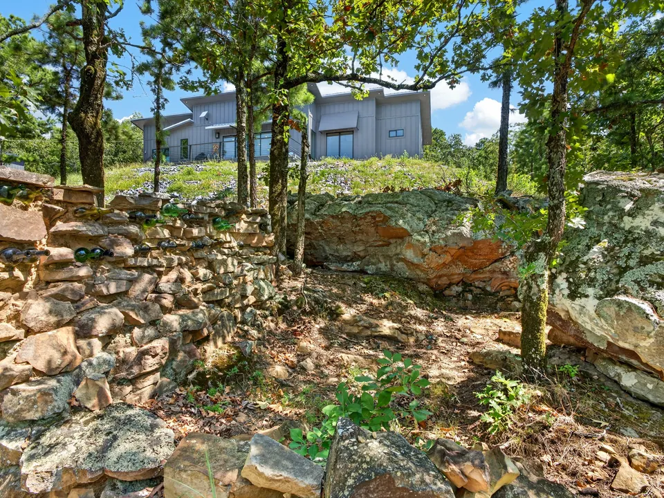 Natural rock and mature trees below 10 Moonshine Drive